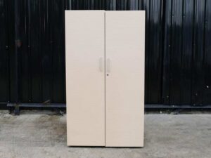 Wooden cabinet with 2 doors, cream color, wavy design.