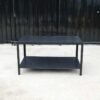 Multipurpose table with 2 levels, black wood pattern top. Black steel leg frame