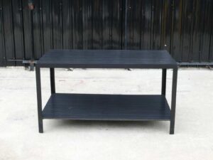 Multipurpose table with 2 levels, black wood pattern top. Black steel leg frame