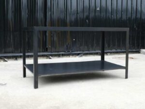 Multipurpose table with 2 levels, black wood pattern top. Black steel leg frame