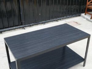 Multipurpose table with 2 levels, black wood pattern top. Black steel leg frame