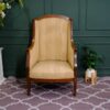 Armchair, wooden frame, fabric cushion, cream color.
