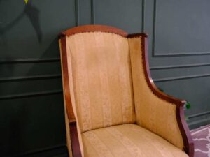 Armchair, wooden frame, fabric cushion, cream color.