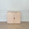 Cabinet for storing documents or items, two-door cabinet, light brown wooden frame.