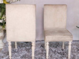 Wooden chair, beige fabric cushion, beautiful design on the legs.