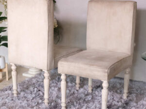 Wooden chair, beige fabric cushion, beautiful design on the legs.