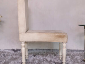 Wooden chair, beige fabric cushion, beautiful design on the legs.