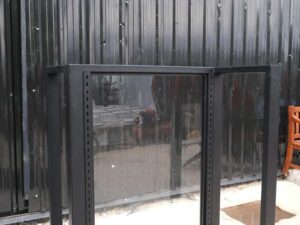 Product shelves, 2 sides, glass divider in the middle Black steel frame, wooden base