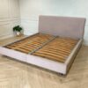 Bed 6 feet, covered with cream-colored fabric. **Only the bed, mattress already sold**