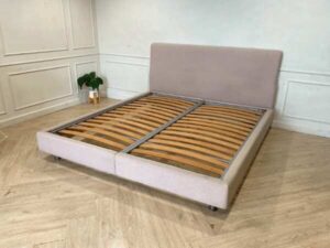 Bed 6 feet, covered with cream-colored fabric. **Only the bed, mattress already sold**