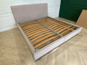 Bed 6 feet, covered with cream-colored fabric. **Only the bed, mattress already sold**