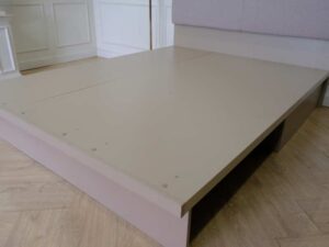 5 foot bed, wooden frame, fabric cushioned headboard, gray color.