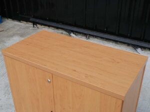 Wooden filing cabinet with 2 doors, black vertical handles