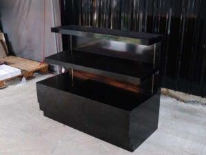3-tiered product shelves, black high-gloss surface There are 2 storage cabinets in the back that open.
