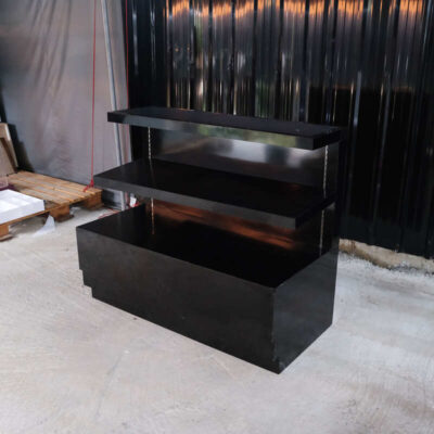 3-tiered product shelves, black high-gloss surface There are 2 storage cabinets in the back that open.