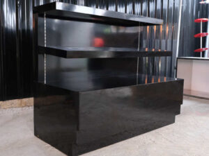 3-tiered product shelves, black high-gloss surface There are 2 storage cabinets in the back that open.