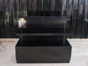 3-tiered product shelves, black high-gloss surface There are 2 storage cabinets in the back that open.