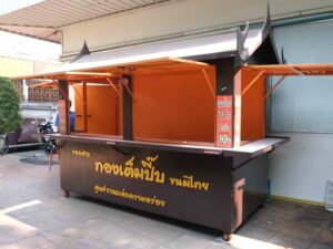 A stall selling goods, a snack stall, made of steel with wheels, designed in Thai style, equipped with water system and electricity system.