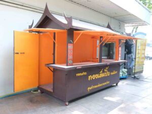 A stall selling goods, a snack stall, made of steel with wheels, designed in Thai style, equipped with water system and electricity system.