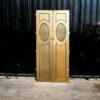 Double wooden doors, round mullions, twist latch, gold color.