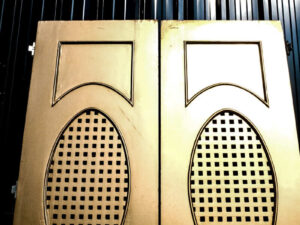 Double wooden doors, round mullions, twist latch, gold color.