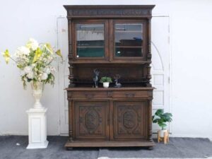 Tall buffet cabinet, carved leaf pattern. European work comes from Germany.