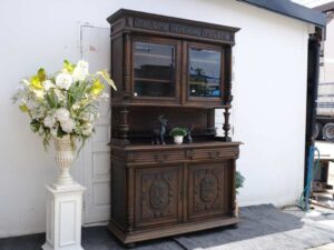 Tall buffet cabinet, carved leaf pattern. European work comes from Germany.