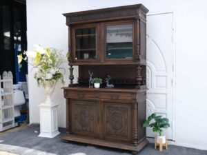 Tall buffet cabinet, carved leaf pattern. European work comes from Germany.