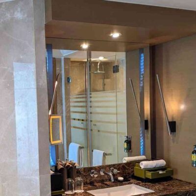 Mirror in the bathroom with lights built in on 2 sides.
