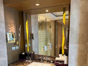 Mirror in the bathroom with lights built in on 2 sides.