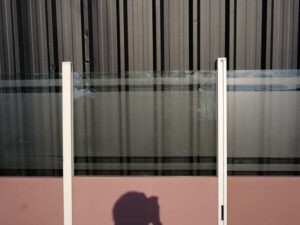 Partition, steel frame, glass top, brown color.