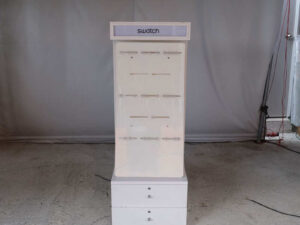 watch display shelf Hanging product display shelf, white wooden frame, with 2 storage drawers.