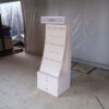 watch display shelf Hanging product display shelf, white wooden frame, with 2 storage drawers.