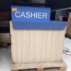 White cashier counter, blue CASHIER sign.