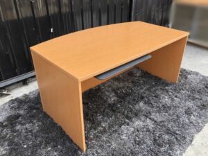 Executive desk With keyboard rail, wooden frame, cream color.