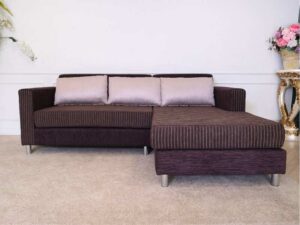 L sofa with pillows, fabric cushions, wooden frame, steel legs, brown.