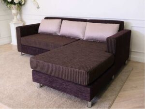 L sofa with pillows, fabric cushions, wooden frame, steel legs, brown.