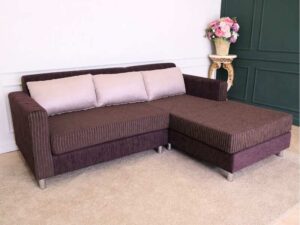 L sofa with pillows, fabric cushions, wooden frame, steel legs, brown.