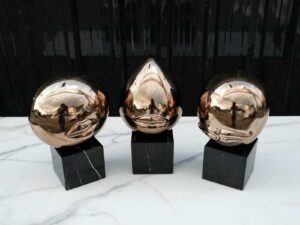 Water decoration, golden shape, black marble base.