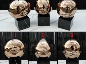 Water decoration, golden shape, black marble base.