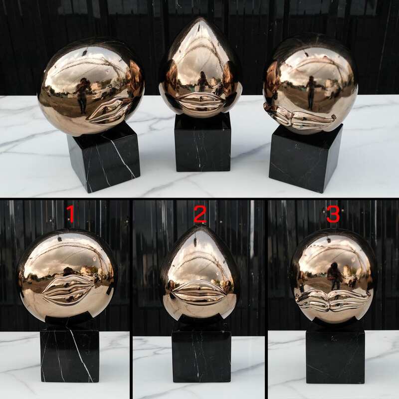 Water decoration, golden shape, black marble base.