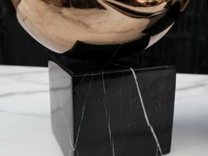 Water decoration, golden shape, black marble base.