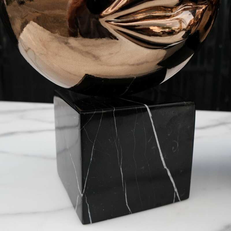 Water decoration, golden shape, black marble base.