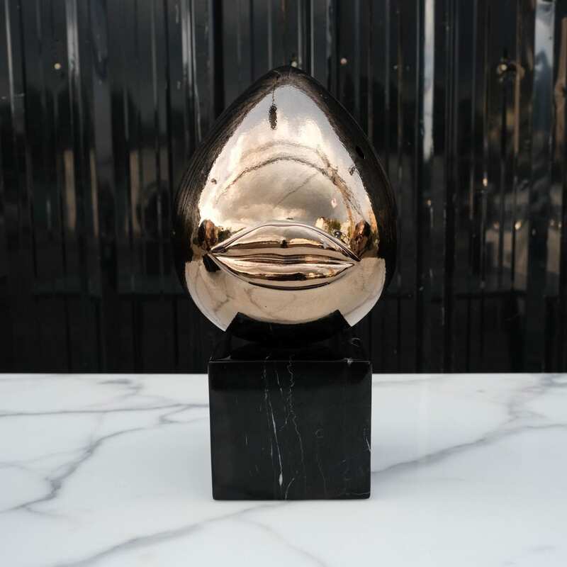 Water decoration, golden shape, black marble base.