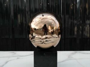 Water decoration, golden shape, black marble base.