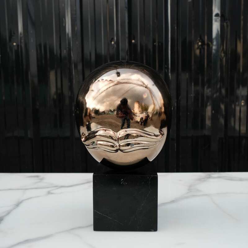 Water decoration, golden shape, black marble base.