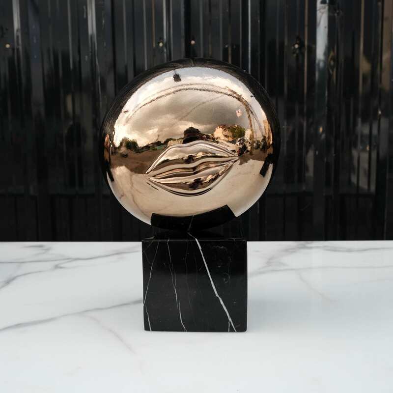 Water decoration, golden shape, black marble base.