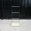 Product hanging rack Product hanging shelf, glass walls on 2 sides, 3 hanging rails, cream colored wooden base.