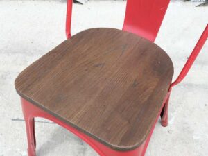 Red steel frame chair with wooden cushion