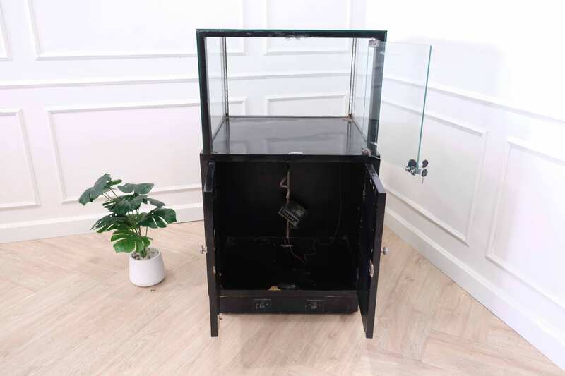 Jewelry cabinet, glass cabinet to display products Square shape, black wooden base, has 2 storage cabinets that open.